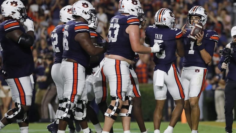 Sep 16, 2023; Auburn, Alabama, USA; Auburn Tigers quarterback Payton Thorne (1) celebrates with teammates after scoring a touchdown against the Samford Bulldogs during the second quarter at Jordan-Hare Stadium. Mandatory Credit: John Reed-USA TODAY Sports