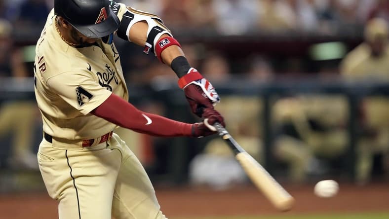 Sep 16, 2023; Phoenix, Arizona, USA; Arizona Diamondbacks left fielder Lourdes Gurriel Jr. (12) hits an RBI single against the Chicago Cubs during the fourth inning at Chase Field. Mandatory Credit: Joe Camporeale-USA TODAY Sports