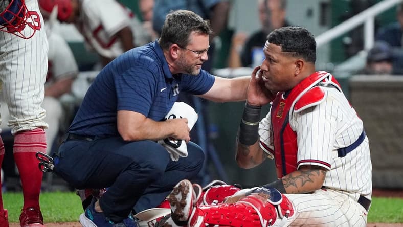 Sep 16, 2023; Kansas City, Missouri, USA; A staff member works with Kansas City Royals catcher Salvador Perez (13) against the Houston Astros after an injury in the fifth inning at Kauffman Stadium. Mandatory Credit: Denny Medley-USA TODAY Sports