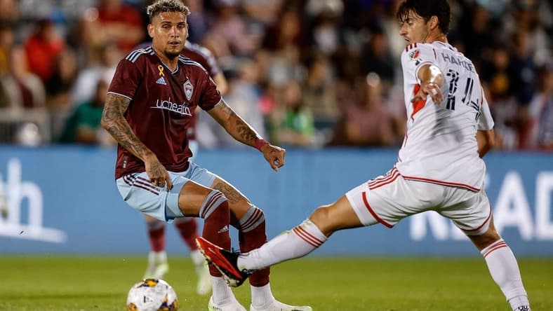 Sep 16, 2023; Commerce City, Colorado, USA; Colorado Rapids forward Rafael Navarro (9) passes the ball as New England Revolution midfielder Ian Harkes (14) defends in the first half at Dick's Sporting Goods Park. Mandatory Credit: Isaiah J. Downing-USA TODAY Sports