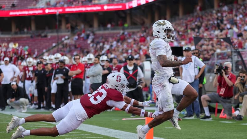 Sep 16, 2023; Stanford, California, USA; Sacramento State Hornets quarterback Kaiden Bennett (1) runs for a touchdown past Stanford Cardinal safety Alaka'i Gilman (33) during the second quarter at Stanford Stadium. Mandatory Credit: Sergio Estrada-USA TODAY Sports