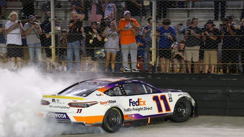 Sep 16, 2023; Bristol, Tennessee, USA; NASCAR Cup Series driver Denny Hamlin (11) does a burnout after winning the Bass Pro Shops Night Race at Bristol Motor Speedway. Mandatory Credit: Randy Sartin-USA TODAY Sports