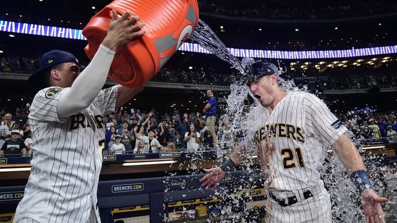 Sep 16, 2023; Milwaukee, Wisconsin, USA;  Milwaukee Brewers left fielder Mark Canha (21) gets dunked by shortstop Willy Adames (27) after beating the Washington Nationals at American Family Field. Mandatory Credit: Benny Sieu-USA TODAY Sports
