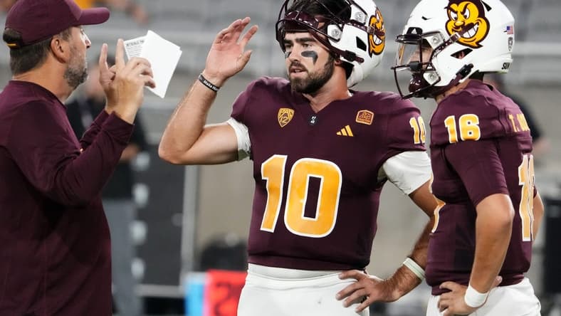 Arizona State Sun Devils offensive coordinator Beau Baldwin talks to his quarterbacks Drew Pyne (10) and Trenton Bourguet (16) during pregame warms-up before playing the Fresno State Bulldogs at Mountain America Stadium in Tempe on Sept. 16, 2023.