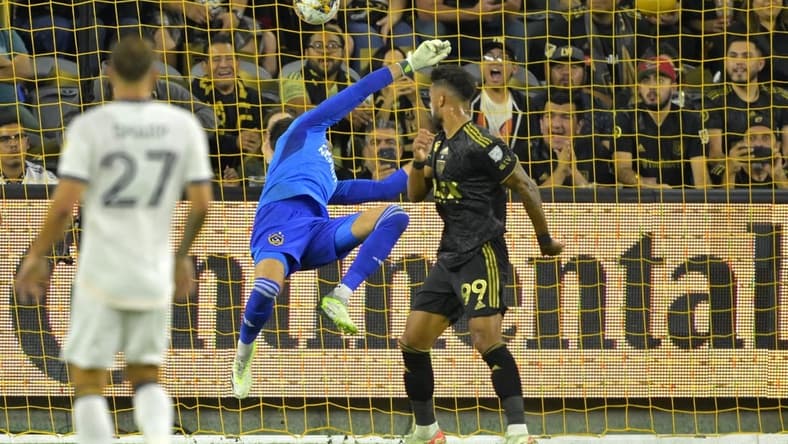 Sep 16, 2023; Los Angeles, California, USA; Los Angeles FC forward Denis Bouanga (99) scores a goal past Los Angeles Galaxy goalkeeper Jonathan Bond (1) off a pass by Los Angeles Galaxy forward Michael Barrios (12) in the first half at BMO Stadium. Mandatory Credit: Jayne Kamin-Oncea-USA TODAY Sports