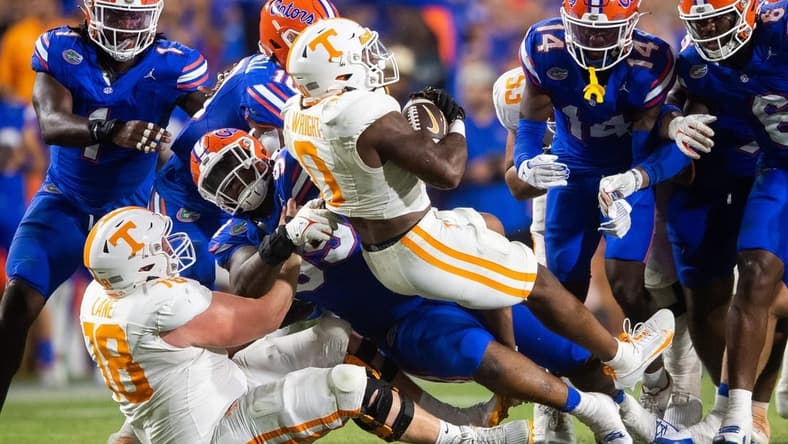 Tennessee running back Jaylen Wright (0) is swarmed by Florida defenders during a football game between Tennessee and Florida at Ben Hill Griffin Stadium in Gainesville, Fla., on Saturday, Sept. 16, 2023.
