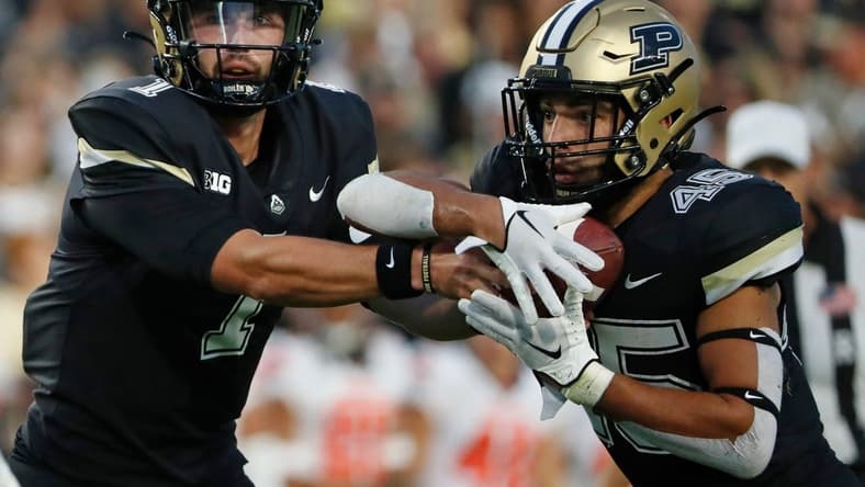 Purdue Boilermakers quarterback Hudson Card (1) hands the ball off to Purdue Boilermakers running back Devin Mockobee (45) during the NCAA football game against the Syracuse Orange, Wednesday, July 12, 2023, at Ross-Ade Stadium in West Lafayette, Ind.