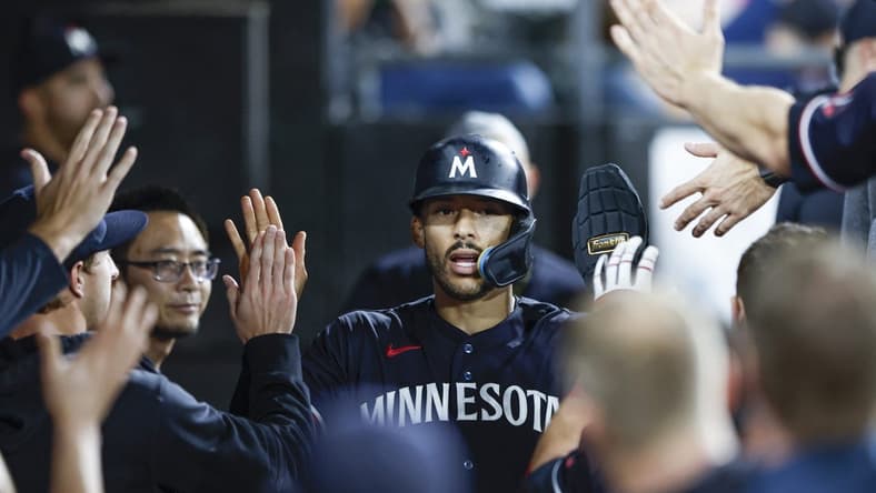Sep 16, 2023; Chicago, Illinois, USA; Minnesota Twins shortstop Carlos Correa (4) celebrates with teammates after scoring against the Chicago White Sox during the eight inning at Guaranteed Rate Field. Mandatory Credit: Kamil Krzaczynski-USA TODAY Sports