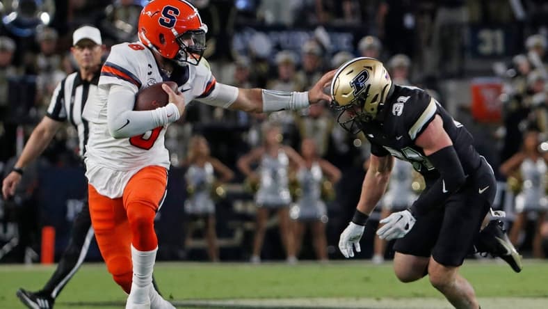 Syracuse Orange quarterback Garrett Shrader (6) stiff arms Purdue Boilermakers defensive back Dillon Thieneman (31) during the NCAA football game, Saturday, Sept. 16, 2023, at Ross-Ade Stadium in West Lafayette, Ind. Syracuse Orange won 35-20.