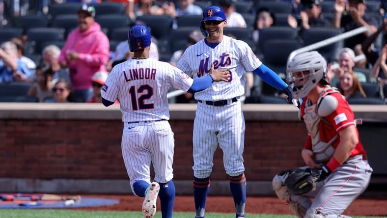 Sep 17, 2023; New York City, New York, USA; New York Mets shortstop Francisco Lindor (12) and designated hitter Brandon Nimmo (9) celebrate after scoring on a double by catcher Francisco Alvarez (not pictured) during the third inning against the Cincinnati Reds at Citi Field. Mandatory Credit: Brad Penner-USA TODAY Sports
