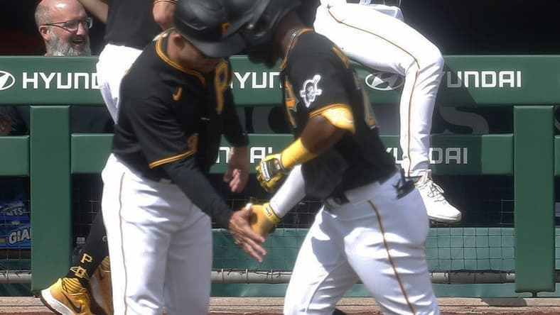 Sep 17, 2023; Pittsburgh, Pennsylvania, USA; Pittsburgh Pirates catcher Endy Rodriguez (25) reacts as left fielder Miguel Andujar (right) circles the bases on a solo home run against the New York Yankees during the fourth inning at PNC Park. Mandatory Credit: Charles LeClaire-USA TODAY Sports