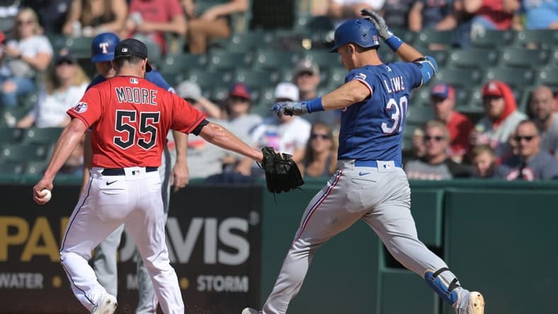 Sep 17, 2023; Cleveland, Ohio, USA; Cleveland Guardians relief pitcher Matt Moore (55) forces out Texas Rangers first baseman Nathaniel Lowe (30) during the seventh inning at Progressive Field. Mandatory Credit: Ken Blaze-USA TODAY Sports