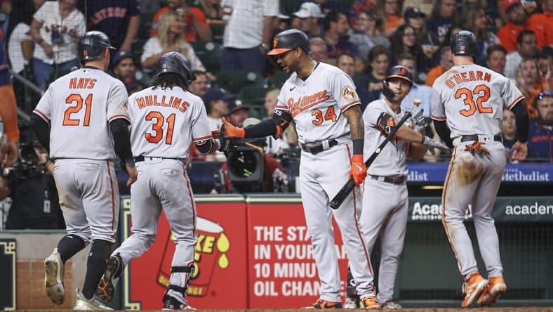 Sep 18, 2023; Houston, Texas, USA; Baltimore Orioles center fielder Cedric Mullins (31) celebrates with right fielder Aaron Hicks (34) after hitting a home run during the ninth inning against the Houston Astros at Minute Maid Park. Mandatory Credit: Troy Taormina-USA TODAY Sports