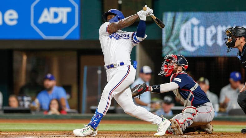Sep 19, 2023; Arlington, Texas, USA; Texas Rangers right fielder Adolis Garcia hits a home run during the second inning against the Boston Red Sox at Globe Life Field. Mandatory Credit: Andrew Dieb-USA TODAY Sports