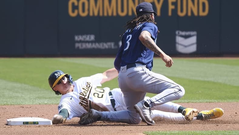 Sep 20, 2023; Oakland, California, USA; Oakland Athletics second baseman Zack Gelof (20) steals second base against Seattle Mariners shortstop J.P. Crawford (3) during the first inning at Oakland-Alameda County Coliseum. Mandatory Credit: Kelley L Cox-USA TODAY Sports