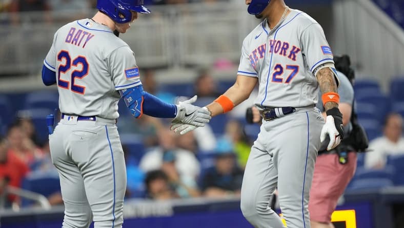 Sep 20, 2023; Miami, Florida, USA; New York Mets designated hitter Mark Vientos (27) is congratulated by third baseman Brett Baty (22) after hitting a solo home run in the second inning against the Miami Marlins at loanDepot Park. Mandatory Credit: Jim Rassol-USA TODAY Sports