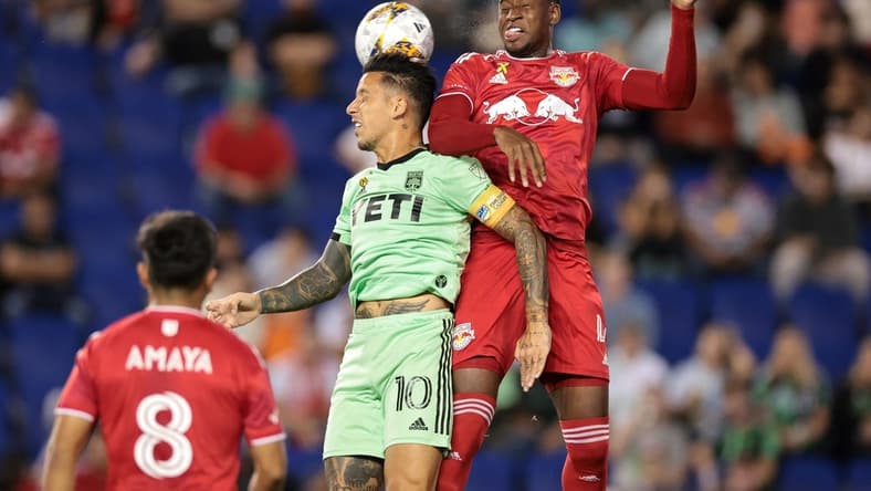 Sep 20, 2023; Harrison, New Jersey, USA; Austin FC forward Sebastian Driussi (10) and New York Red Bulls defender Andres Reyes (4) jump for a header in the first half at Red Bull Arena. Mandatory Credit: Vincent Carchietta-USA TODAY Sports
