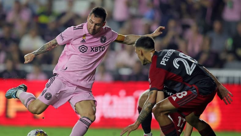 Sep 20, 2023; Fort Lauderdale, Florida, USA; Inter Miami forward Lionel Messi (10) shoots the ball against Toronto FC defender Raoul Petretta (28) during the first half at DRV PNK Stadium. Mandatory Credit: Sam Navarro-USA TODAY Sports