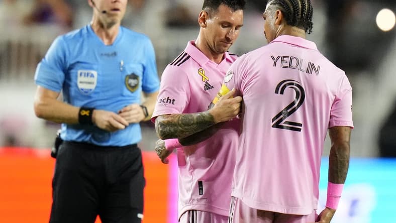 Sep 20, 2023; Fort Lauderdale, Florida, USA; Inter Miami forward Lionel Messi (10) places the captains armband on defender DeAndre Yedlin (2) during the first half at DRV PNK Stadium. Mandatory Credit: Rich Storry-USA TODAY Sports