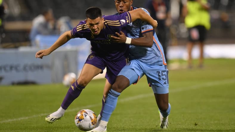 Sep 20, 2023; Queens, New York, USA; Orlando City SC midfielder Cesar Araujo (5) and New York City FC midfielder Andres Perea (15) battle for the ball during the first half at Citi Field. Mandatory Credit: John Jones-USA TODAY Sports