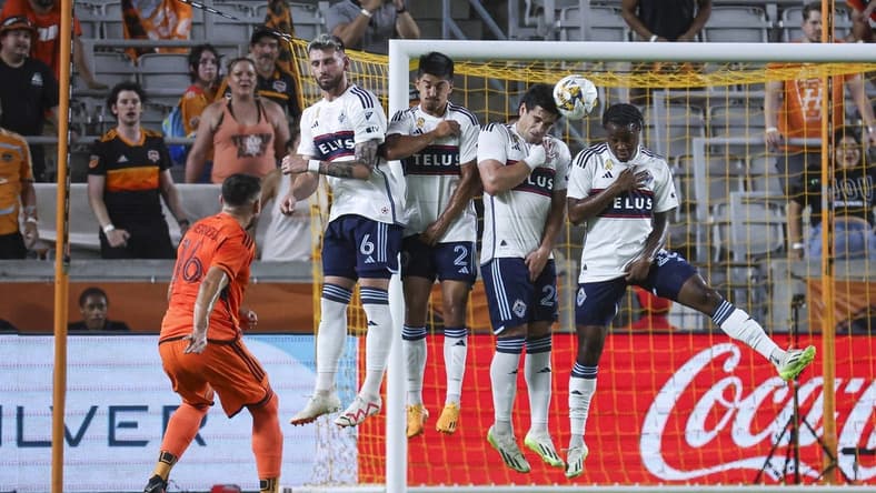 Sep 20, 2023; Houston, Texas, USA; Houston Dynamo FC midfielder Hector Herrera (16) shoots the ball past Vancouver Whitecaps FC defenders to score a goal during the first half at Shell Energy Stadium. Mandatory Credit: Troy Taormina-USA TODAY Sports