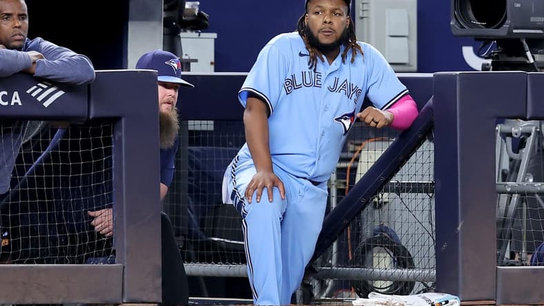 Sep 20, 2023; Bronx, New York, USA; Toronto Blue Jays designated hitter Vladimir Guerrero Jr. (27) watches from the dugout during the eighth inning against the New York Yankees at Yankee Stadium. Mandatory Credit: Brad Penner-USA TODAY Sports