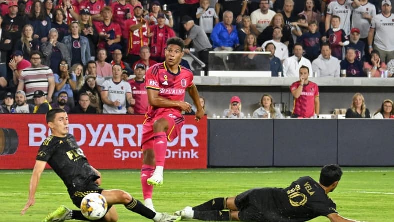 Sep 20, 2023; St. Louis, Missouri, USA; St. Louis City forward Nicholas Gioacchini (11) shoots against Los Angeles FC defender Sergi Palencia (30) and forward Carlos Vela (10) during the second half at CITYPARK. Mandatory Credit: Scott Rovak-USA TODAY Sports