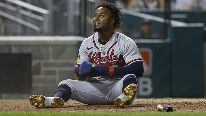 Sep 21, 2023; Washington, District of Columbia, USA; Atlanta Braves second baseman Ozzie Albies (1) sits at home plate after scoring a run on a single by Braves third baseman Austin Riley (not pictured) against the Washington Nationals during the third inning at Nationals Park. Mandatory Credit: Geoff Burke-USA TODAY Sports