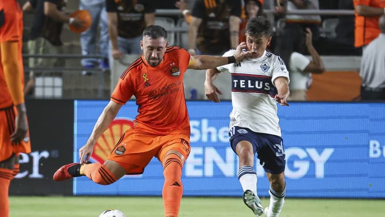 Sep 20, 2023; Houston, Texas, USA; Houston Dynamo FC midfielder Hector Herrera (16) kicks the ball as Vancouver Whitecaps FC midfielder Andres Cubas (20) defends during the first half at Shell Energy Stadium. Mandatory Credit: Troy Taormina-USA TODAY Sports