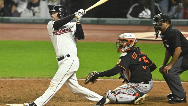 Sep 22, 2023; Cleveland, Ohio, USA; Cleveland Guardians catcher David Fry (12) hits a game-winning, two-RBI double in the ninth inning against the Baltimore Orioles at Progressive Field. Mandatory Credit: David Richard-USA TODAY Sports