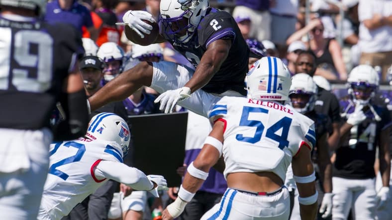 Sep 23, 2023; Fort Worth, Texas, USA; TCU Horned Frogs running back Trey Sanders (2) attempts to leap over SMU Mustangs safety Cale Sanders Jr. (22) during the first half at Amon G. Carter Stadium. Mandatory Credit: Jerome Miron-USA TODAY Sports
