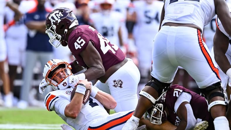 Sep 23, 2023; College Station, Texas, USA; Texas A&M Aggies linebacker Edgerrin Cooper (45) sacks Auburn Tigers quarterback Payton Thorne (1) during the first half at Kyle Field. Mandatory Credit: Maria Lysaker-USA TODAY Sports