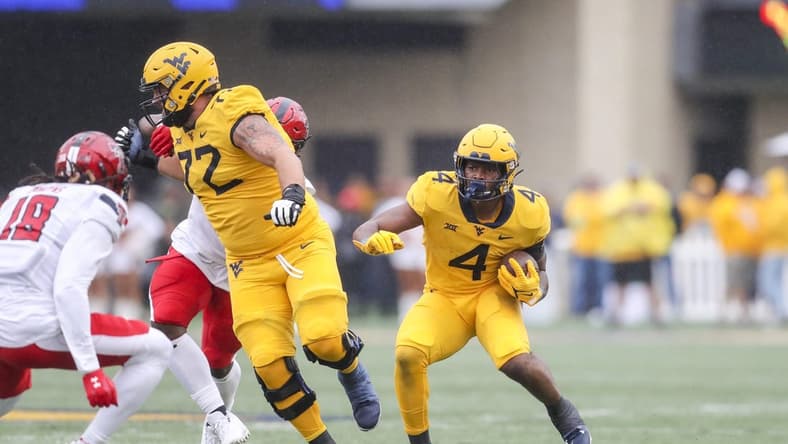 Sep 23, 2023; Morgantown, West Virginia, USA; West Virginia Mountaineers running back CJ Donaldson Jr. (4) runs the ball during the first quarter against the Texas Tech Red Raiders at Mountaineer Field at Milan Puskar Stadium. Mandatory Credit: Ben Queen-USA TODAY Sports