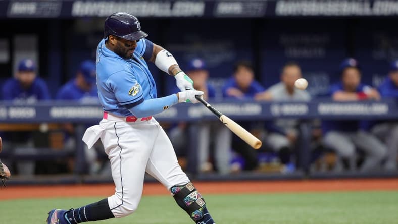 Sep 23, 2023; St. Petersburg, Florida, USA; Tampa Bay Rays first baseman Yandy Diaz (2) hits a solo home run against the Toronto Blue Jays in the first inning at Tropicana Field. Mandatory Credit: Nathan Ray Seebeck-USA TODAY Sports