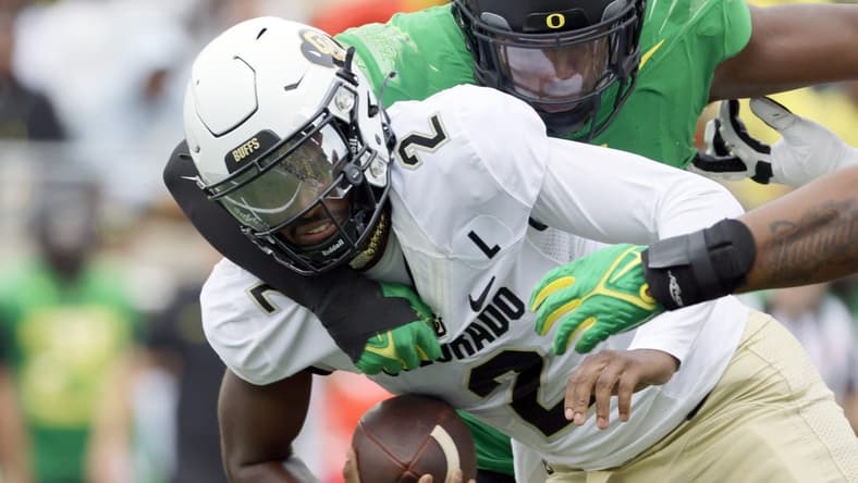 Sep 23, 2023; Eugene, Oregon, USA; Oregon Ducks defensive end Jordan Burch (1) sacks Colorado Buffaloes quarterback Shedeur Sanders (2) during the first half at Autzen Stadium. Mandatory Credit: Soobum Im-USA TODAY Sports