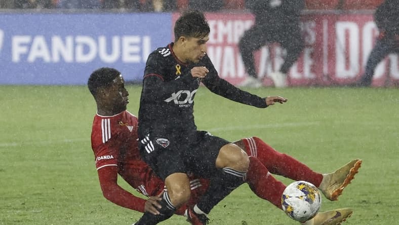 Sep 23, 2023; Washington, District of Columbia, USA; D.C. United Gabriel Pirani (10) is tackled by New York Red Bulls defender Andr s Reyes (4) while dribbling the ball in the box in the first half at Audi Field. Mandatory Credit: Geoff Burke-USA TODAY Sports