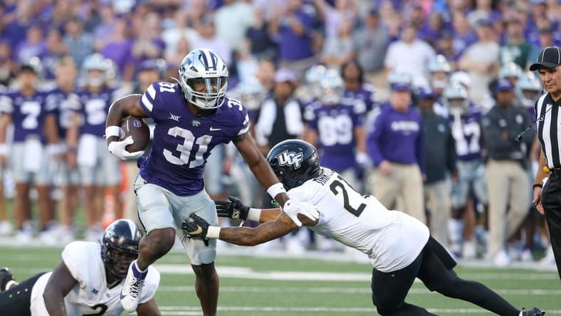 Sep 23, 2023; Manhattan, Kansas, USA; UCF Knights defensive back Nikai Martinez (21) misses a tackle on Kansas State Wildcats running back DJ Giddens (31) during the first quarter at Bill Snyder Family Football Stadium. Mandatory Credit: Scott Sewell-USA TODAY Sports