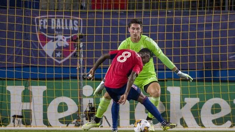 Sep 23, 2023; Frisco, Texas, USA; Columbus Crew goalkeeper Patrick Schulte (28) stops a shot by FC Dallas forward Jader Obrian (8) during the first half at Toyota Stadium. Mandatory Credit: Jerome Miron-USA TODAY Sports