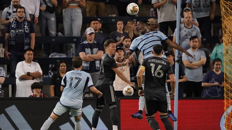 Sep 23, 2023; Kansas City, Kansas, USA; Sporting Kansas City defender Dany Rosero (5) and Houston Dynamo forward Corey Baird (11) go up for a header during the second half at Children's Mercy Park. Mandatory Credit: Denny Medley-USA TODAY Sports