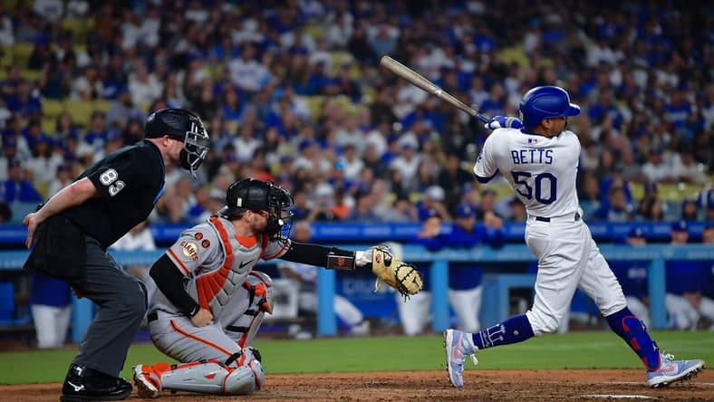Sep 23, 2023; Los Angeles, California, USA; Los Angeles Dodgers second baseman Mookie Betts (50) hits a two run RBI double against the San Francisco Giants during the eighth inning at Dodger Stadium. Mandatory Credit: Gary A. Vasquez-USA TODAY Sports