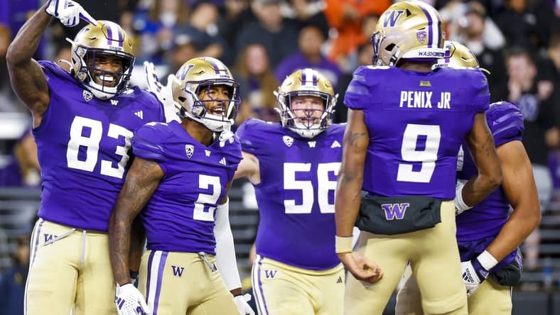 Sep 23, 2023; Seattle, Washington, USA; Washington Huskies wide receiver JaLynn Polk (2) celebrates with tight end Devin Culp (83), offensive lineman Geirean Hatchett (56) and quarterback Michael Penix Jr. (9) after catching a touchdown pass against the California Golden Bears during the second quarter at Alaska Airlines Field at Husky Stadium. Mandatory Credit: Joe Nicholson-USA TODAY Sports
