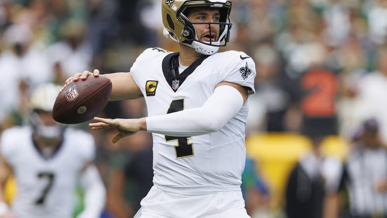Sep 24, 2023; Green Bay, Wisconsin, USA; New Orleans Saints quarterback Derek Carr (4) throws a pass during the first quarter against the Green Bay Packers at Lambeau Field. Mandatory Credit: Jeff Hanisch-USA TODAY Sports