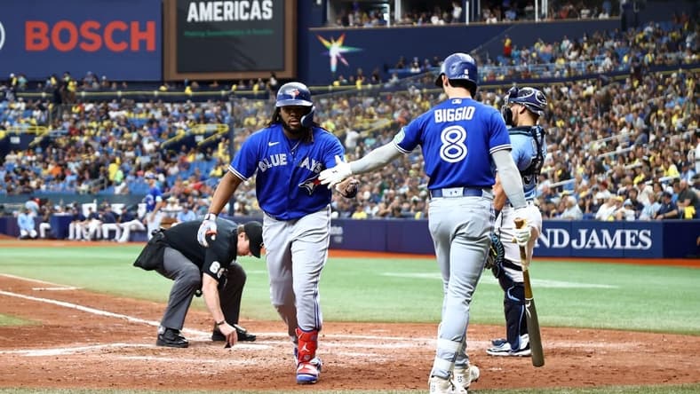 Sep 24, 2023; St. Petersburg, Florida, USA; Toronto Blue Jays first baseman Vladimir Guerrero Jr. (27) is congratulated by second baseman Cavan Biggio (8) after he hit a home run against the Tampa Bay Rays during the sixth inning at Tropicana Field. Mandatory Credit: Kim Klement Neitzel-USA TODAY Sports