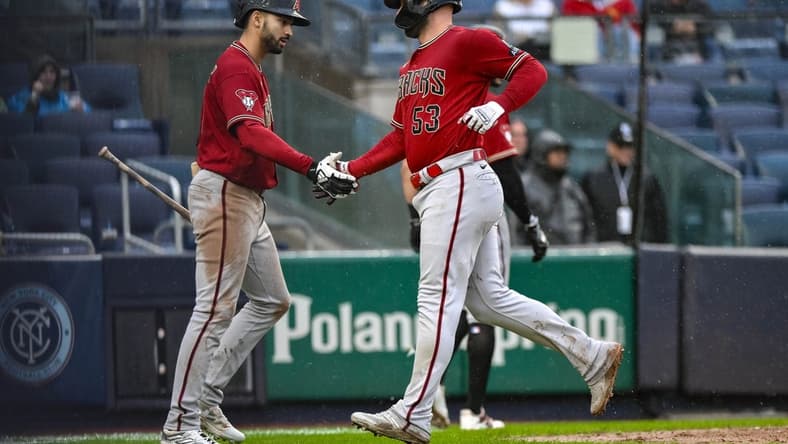 Sep 24, 2023; Bronx, New York, USA; Arizona Diamondbacks first baseman Christian Walker (53) is greeted by Arizona Diamondbacks shortstop Jordan Lawlar (10) after scoring on a two RBI single by Arizona Diamondbacks third baseman Evan Longoria (not pictured) during the seventh inning against the New York Yankees at Yankee Stadium. Mandatory Credit: John Jones-USA TODAY Sports
