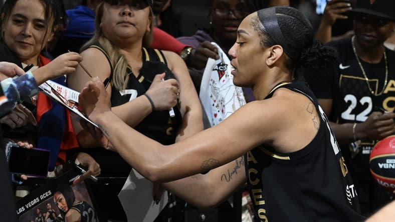 Sep 26, 2023; Las Vegas, Nevada, USA; Las Vegas Aces forward A'ja Wilson (22) signs autographs after defeating the Dallas Wings in game two of the 2023 WNBA Playoffs at Michelob Ultra Arena. Mandatory Credit: Candice Ward-USA TODAY Sports