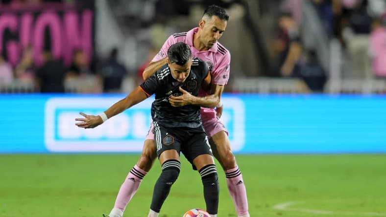 Sep 27, 2023; Fort Lauderdale, FL, USA; Houston Dynamo midfielder Amine Bassi (8) battles for the ball against Inter Miami CF midfielder Sergio Busquets (5) during the first half at DRV PNK Stadium. Mandatory Credit: Sam Navarro-USA TODAY Sports