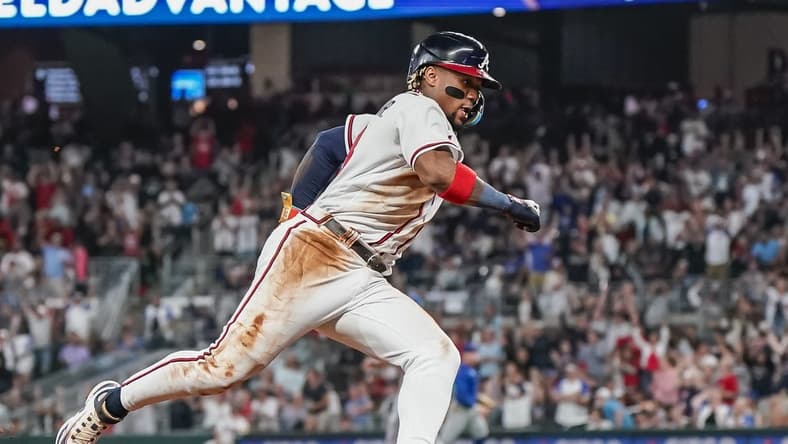 Sep 27, 2023; Cumberland, Georgia, USA; Atlanta Braves right fielder Ronald Acuna Jr. (13) rounds third base on his way to scoring a run against the Chicago Cubs during the eighth inning at Truist Park. Mandatory Credit: Dale Zanine-USA TODAY Sports