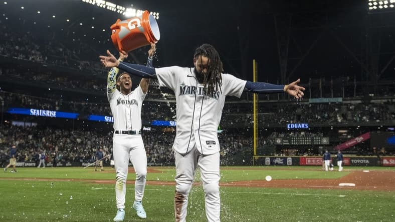 Sep 28, 2023; Seattle, Washington, USA; Seattle Mariners centerfielder Julio Rodriguez (44) dumps a bucket of water on shortstop J.P. Crawford (3) while celebrating after a game against the Texas Rangers at T-Mobile Park. Mandatory Credit: Stephen Brashear-USA TODAY Sports