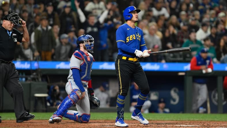 Sep 29, 2023; Seattle, Washington, USA; Seattle Mariners second baseman Josh Rojas (4) hits a home run against the Texas Rangers during the third inning at T-Mobile Park. Mandatory Credit: Steven Bisig-USA TODAY Sports
