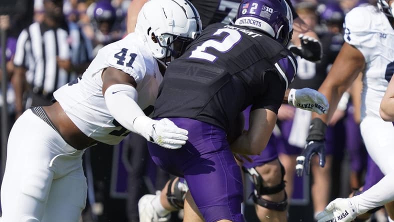 Sep 30, 2023; Evanston, Illinois, USA; Penn State Nittany Lions linebacker Kobe King (41) sacks Northwestern Wildcats quarterback Ben Bryant (2) during the first half at Ryan Field. Mandatory Credit: David Banks-USA TODAY Sports